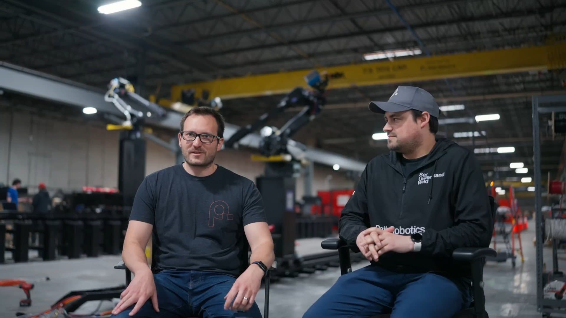 Andy and Alex Lonsberry seated on the Path Robotics shop floor